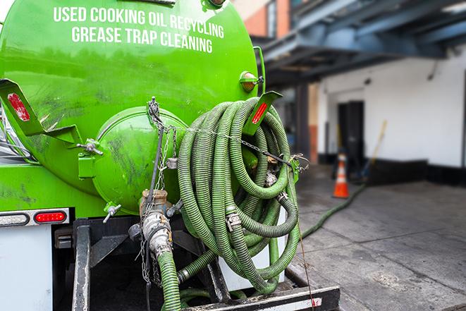 a grease trap pumping truck at a restaurant in Aurora